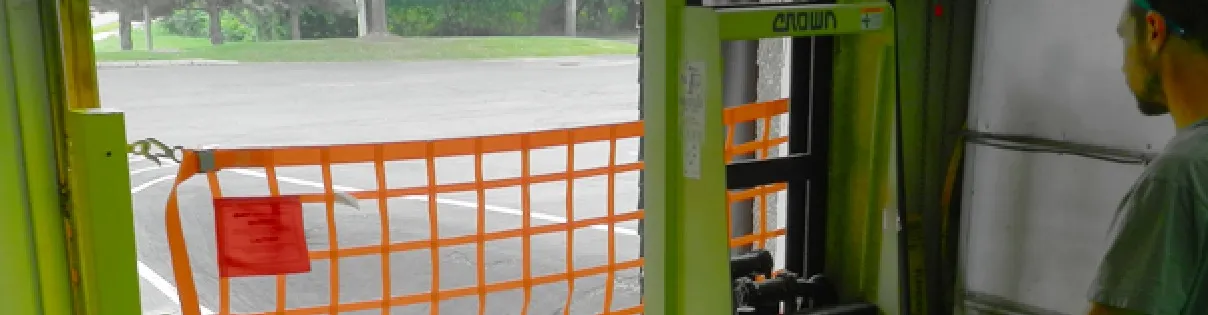 Orange loading dock safety net installed on a loading dock. 