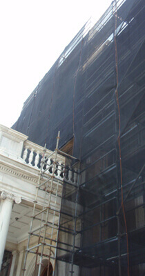 Scaffolding covered with debris netting