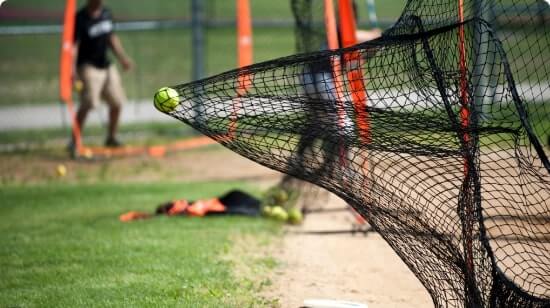 Netting stopping a baseball in a batting cage