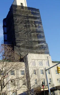 Building covered in debris netting